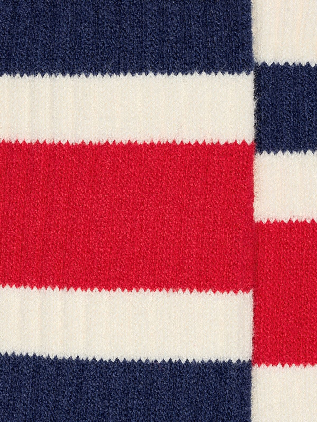 Worn-white socks with distressed details and black and red stripes