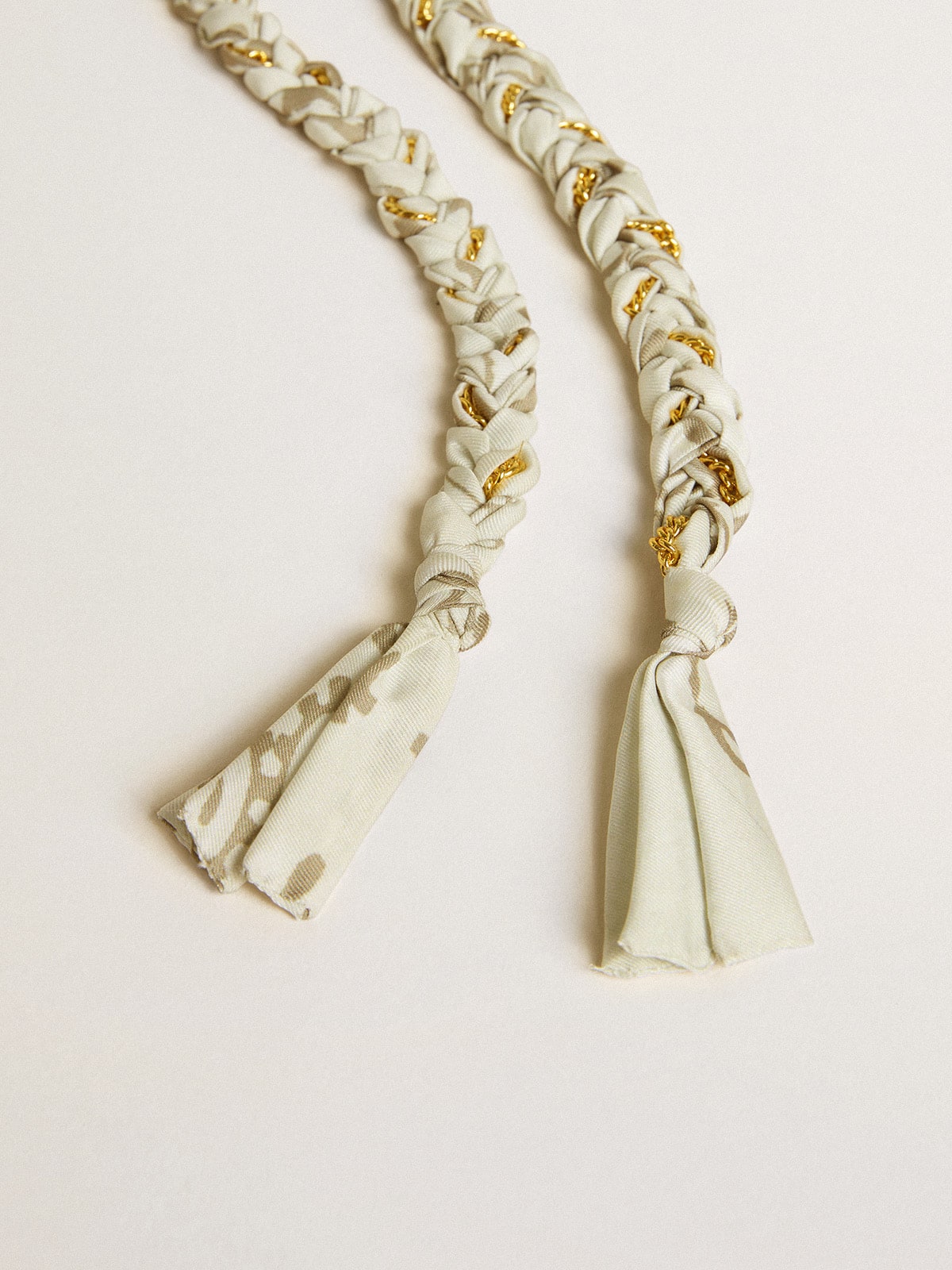 Butter-colored braided fabric charm with brass chain