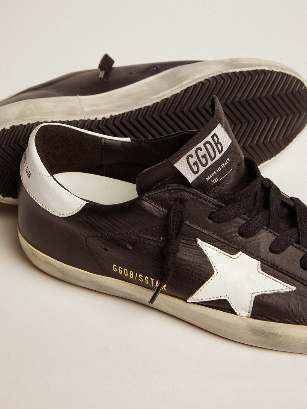 Women’s Super-Star in black leather with white leather star and heel tab
