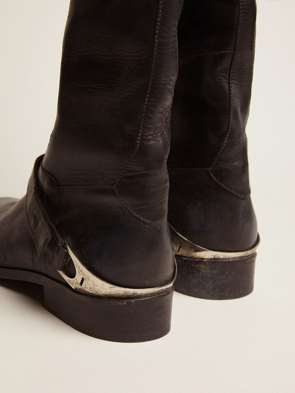 Women's black leather boots with clamp on the heel