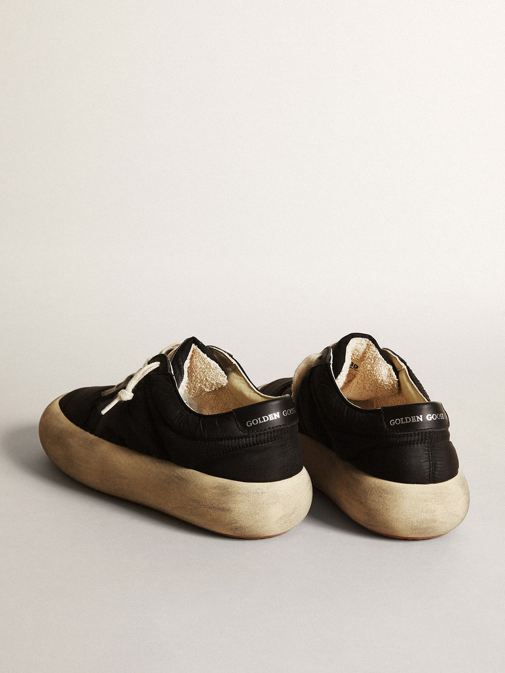 Space-Star shoes in black nylon with black leather star and heel tab