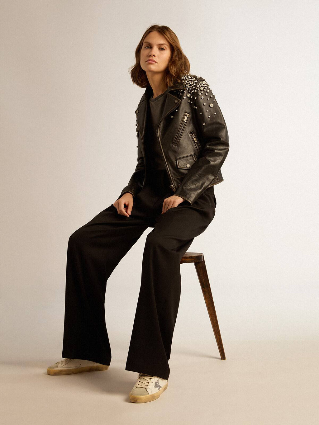 Women's biker jacket in distressed leather with cabochon crystals