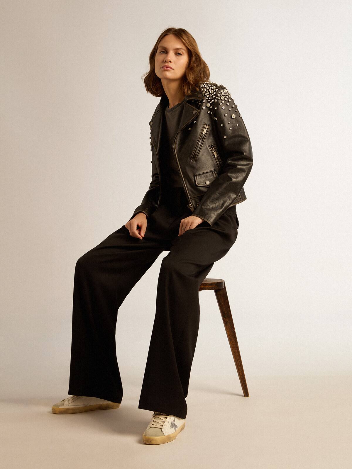 Women's biker jacket in distressed leather with cabochon crystals
