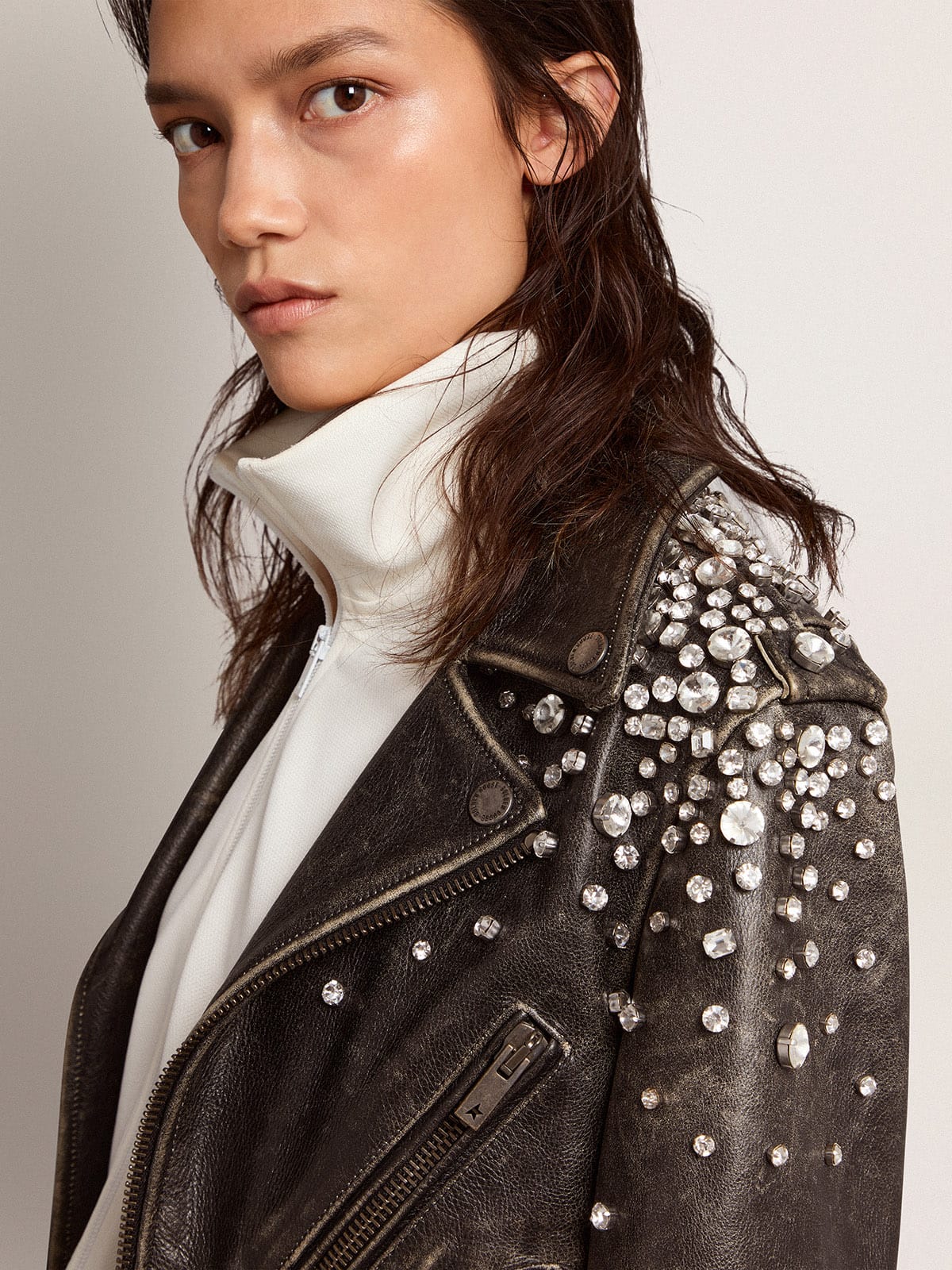 Women's biker jacket in distressed leather with cabochon crystals