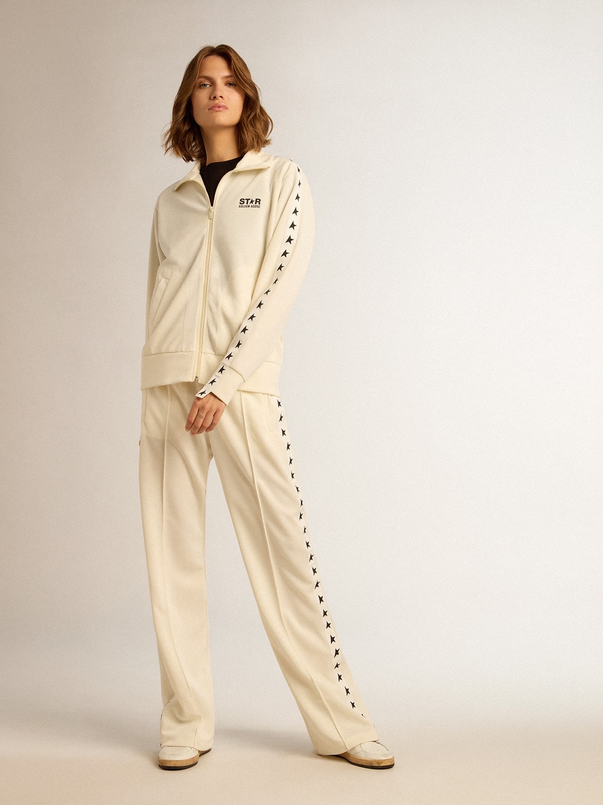 Women’s white zipped sweatshirt with white strip and black stars