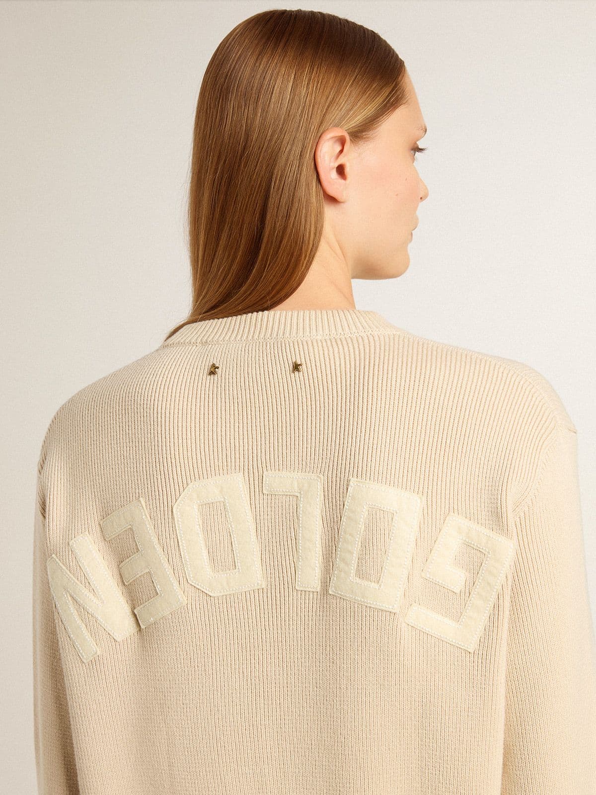 Women's beige sweater with 'Golden' lettering on the back