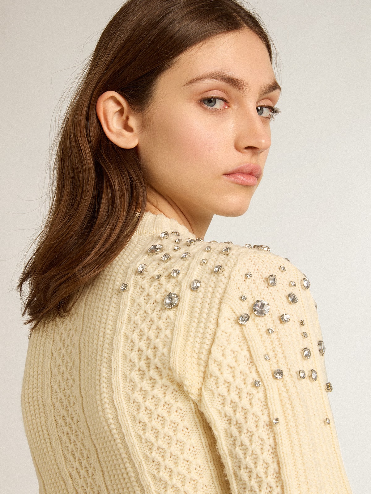 Women's cropped worn-white sweater with decorative crystals