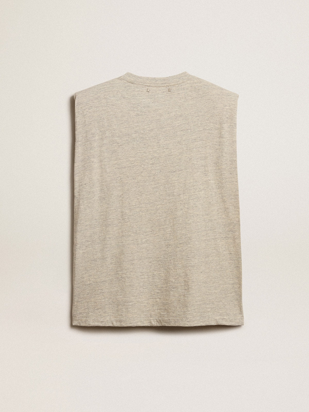 Aged white sleeveless T-shirt with padded shoulder and pearls