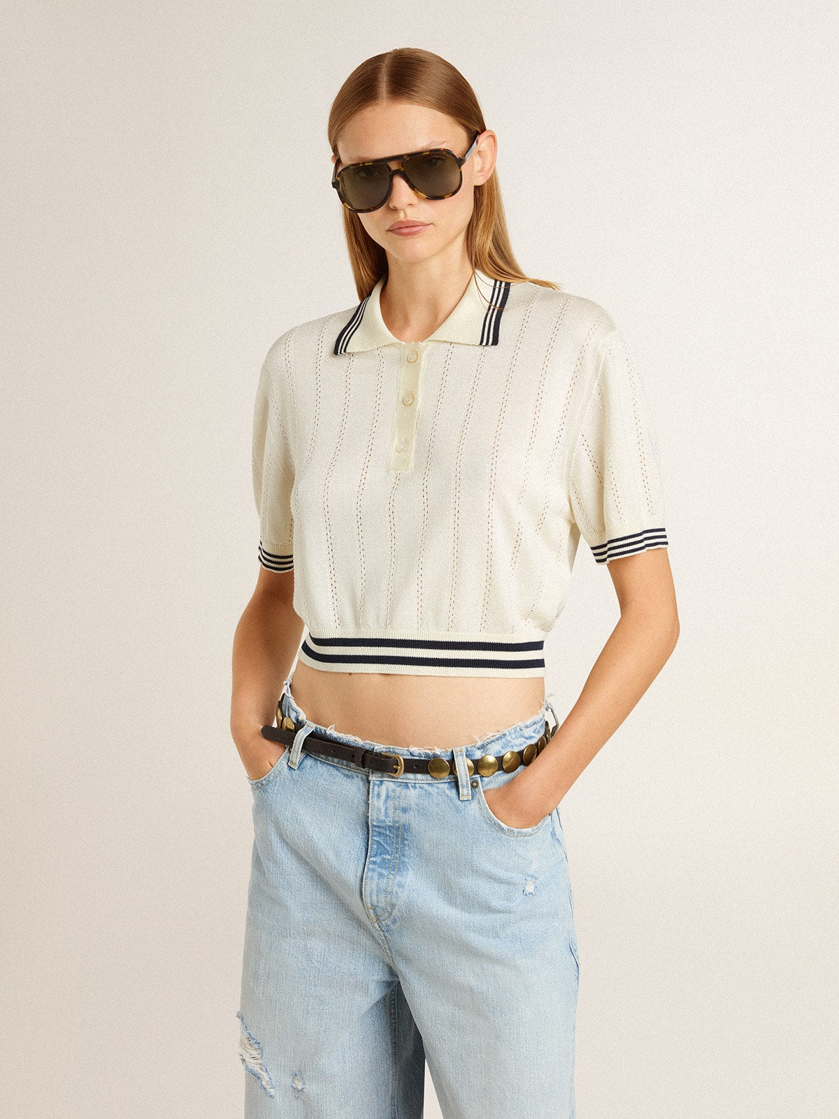 Women's cropped worn-white cotton polo shirt with blue ribbing