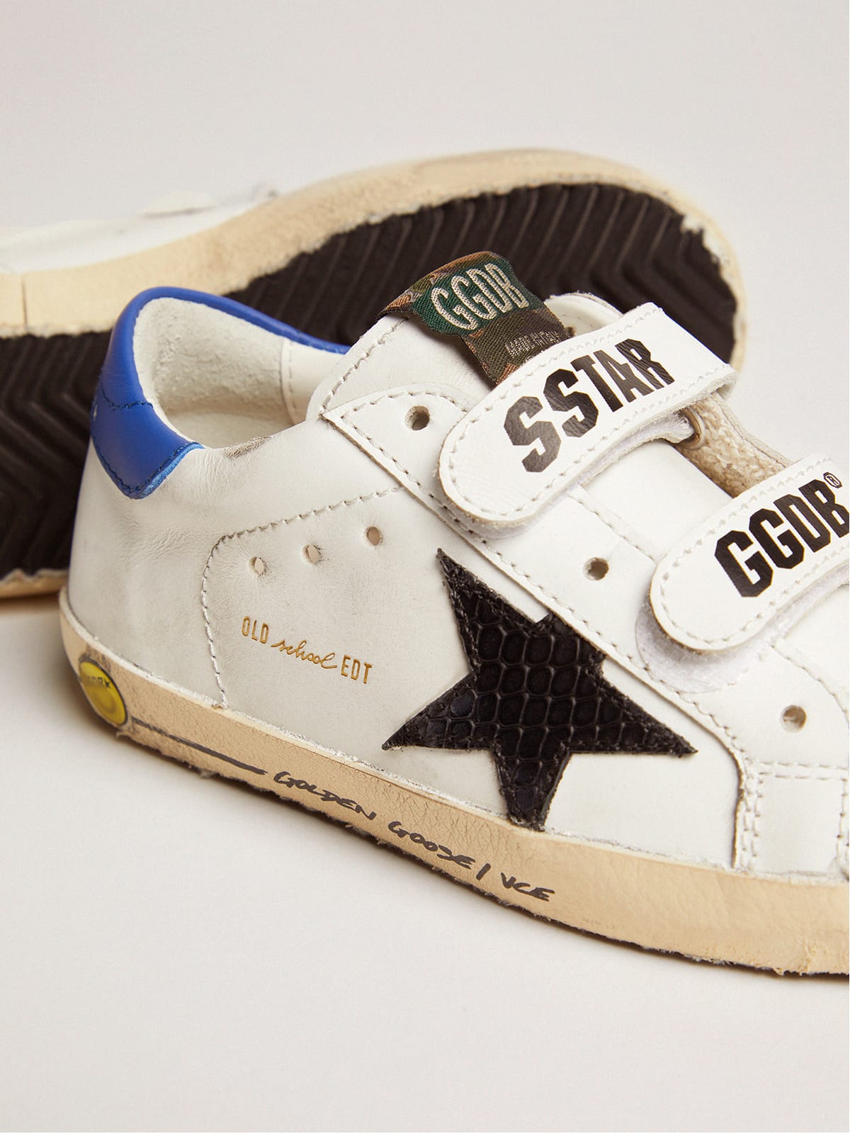 Young Old School with black snake print leather star and blue heel