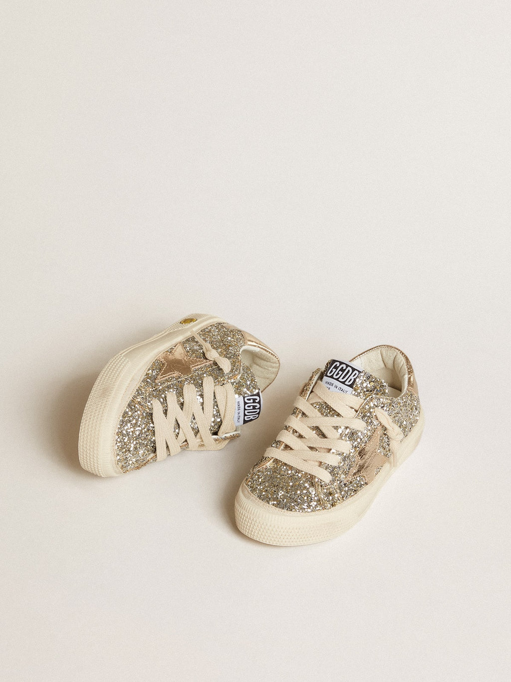 May Young in platinum glitter with metallic leather star and heel tab