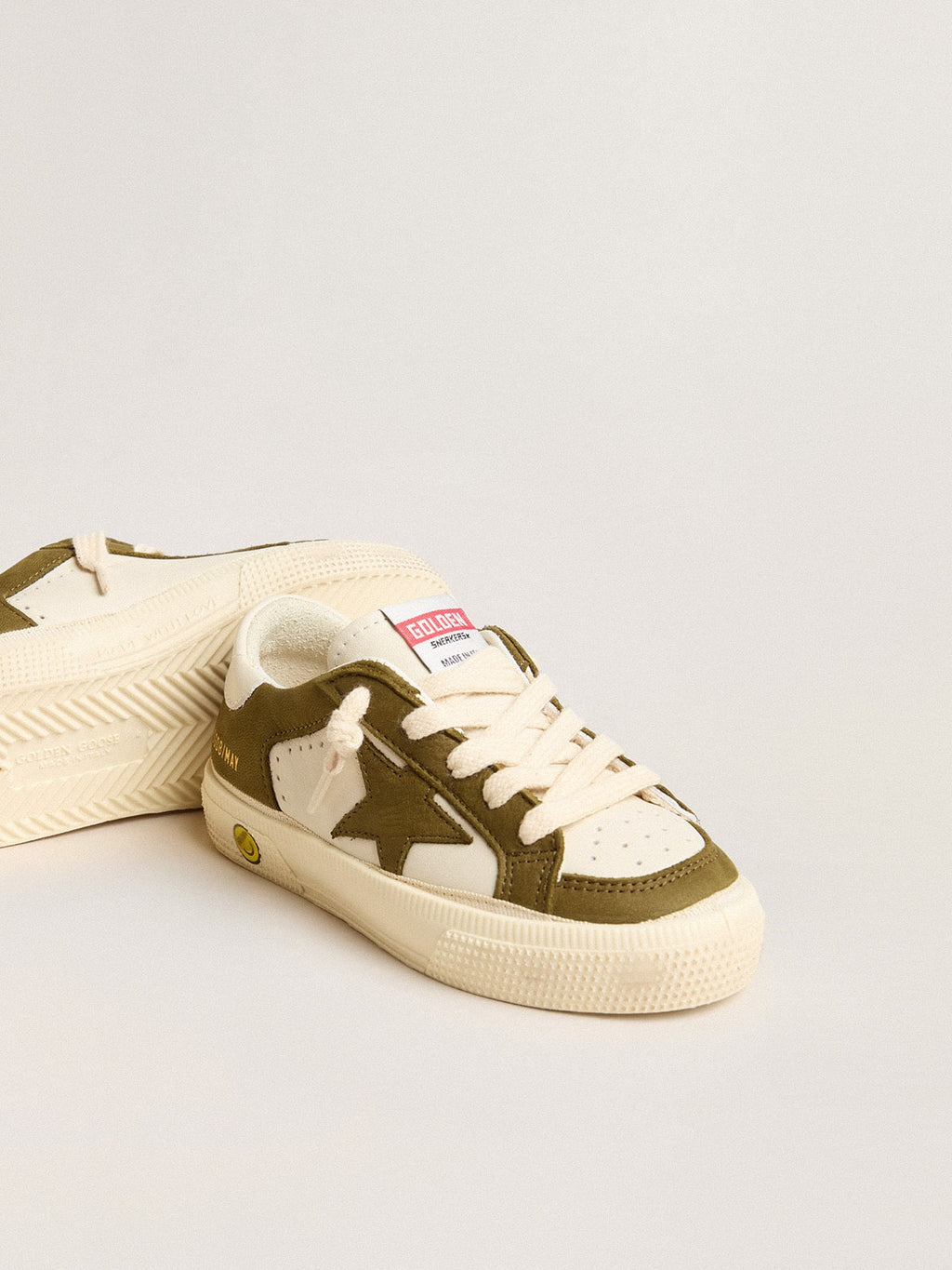 May Young in white and military green leather